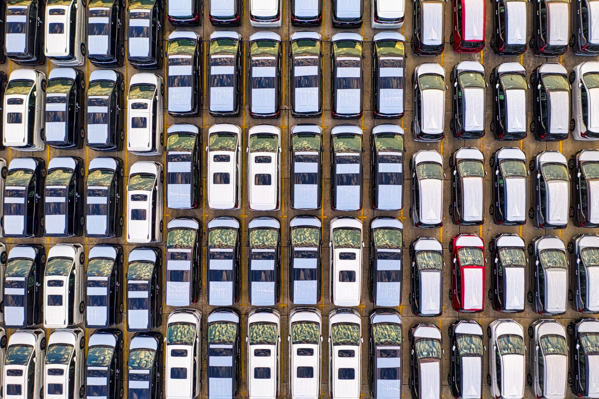 Aerial view of hundreds of vehicles in rows