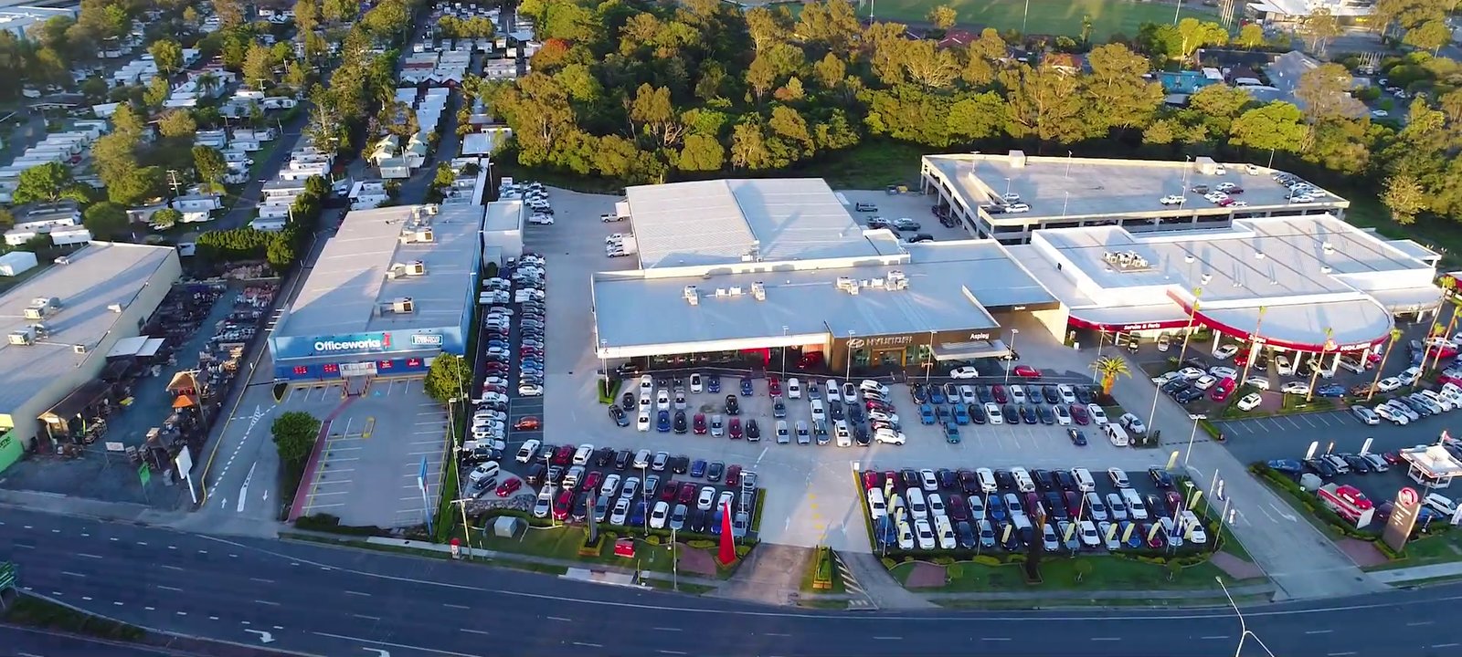 Aerial view of a dealership Detailed services, at golden hour