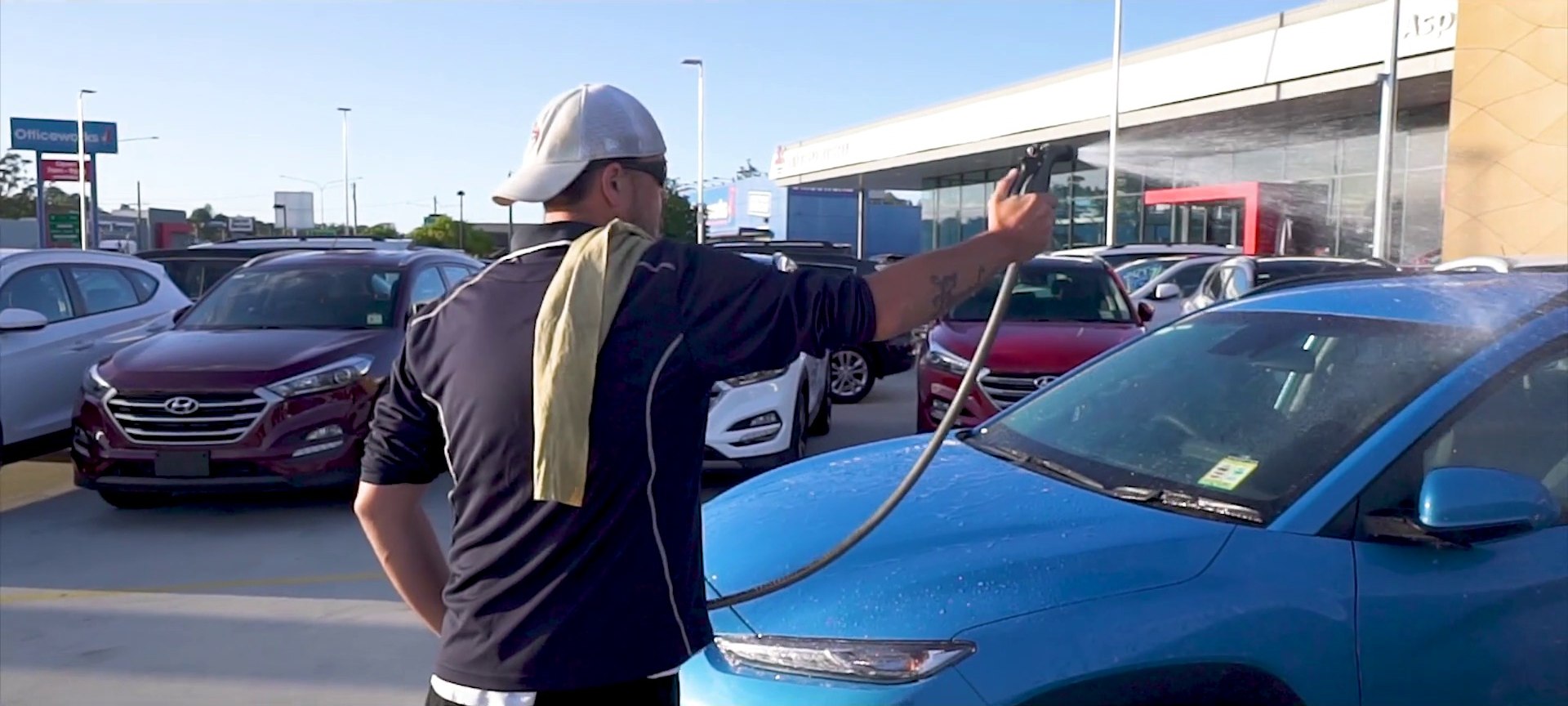 A Detailed team member cleaning vehicles at a dealership